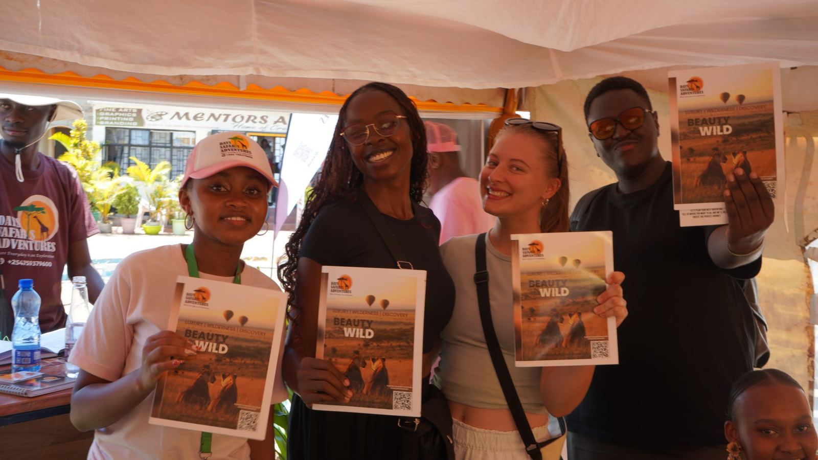 Visitors holding the Beauty of the Wild brochure at our stand
