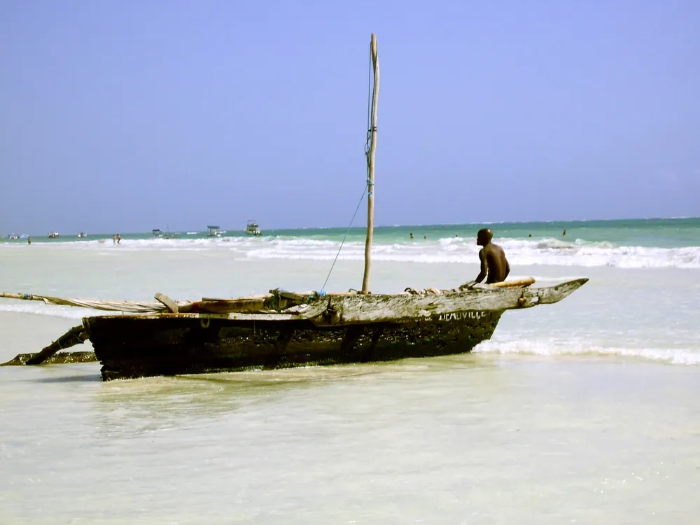 Traditional boats and white sand at Diani Beach, Kenya